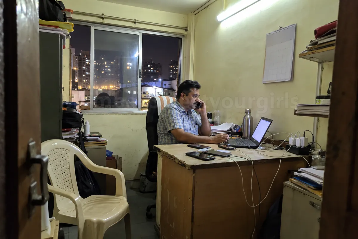 A small escort agency office in Mumbai with phones on the desk